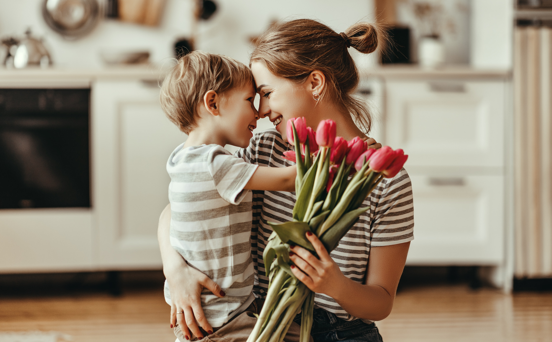 happy mother's day! child son gives flowers for  mother on holiday